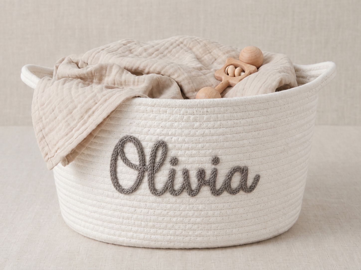 Illustrative cream rope basket with Olivia in grey embroidery